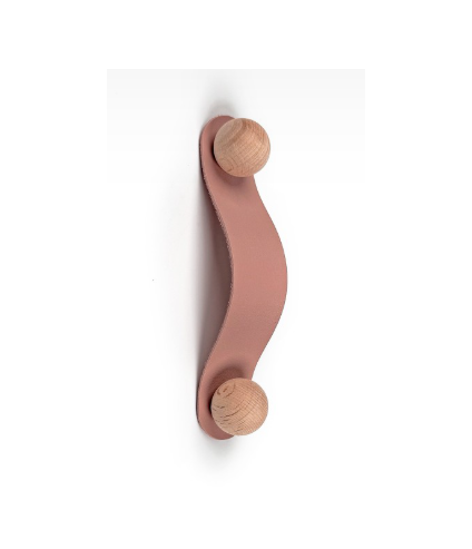 Single muted pink leather loop drawer handle with a round wooden stud on a white background.