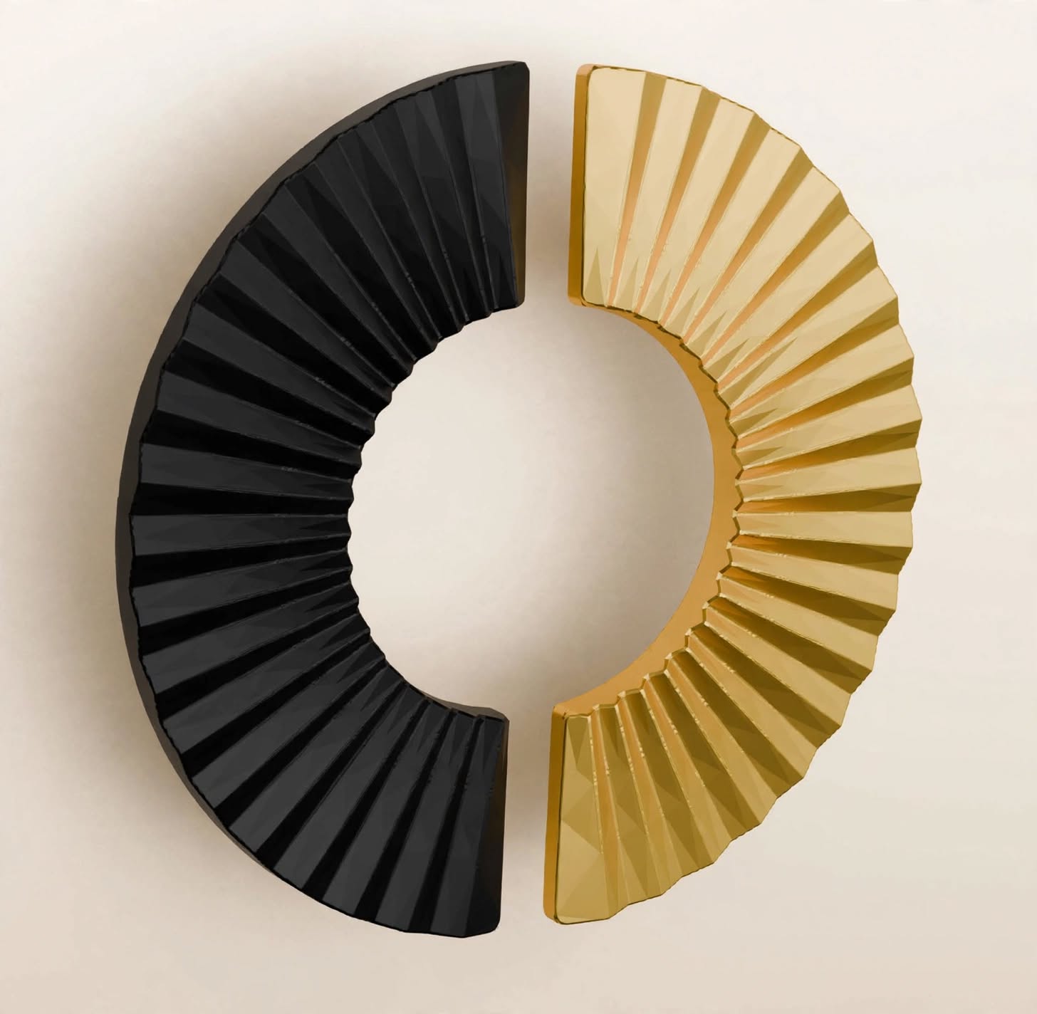 Two half-moon Stillium Oaza cabinet handles in gun metal anthracite and polished gold placed side by side to form a circular motif