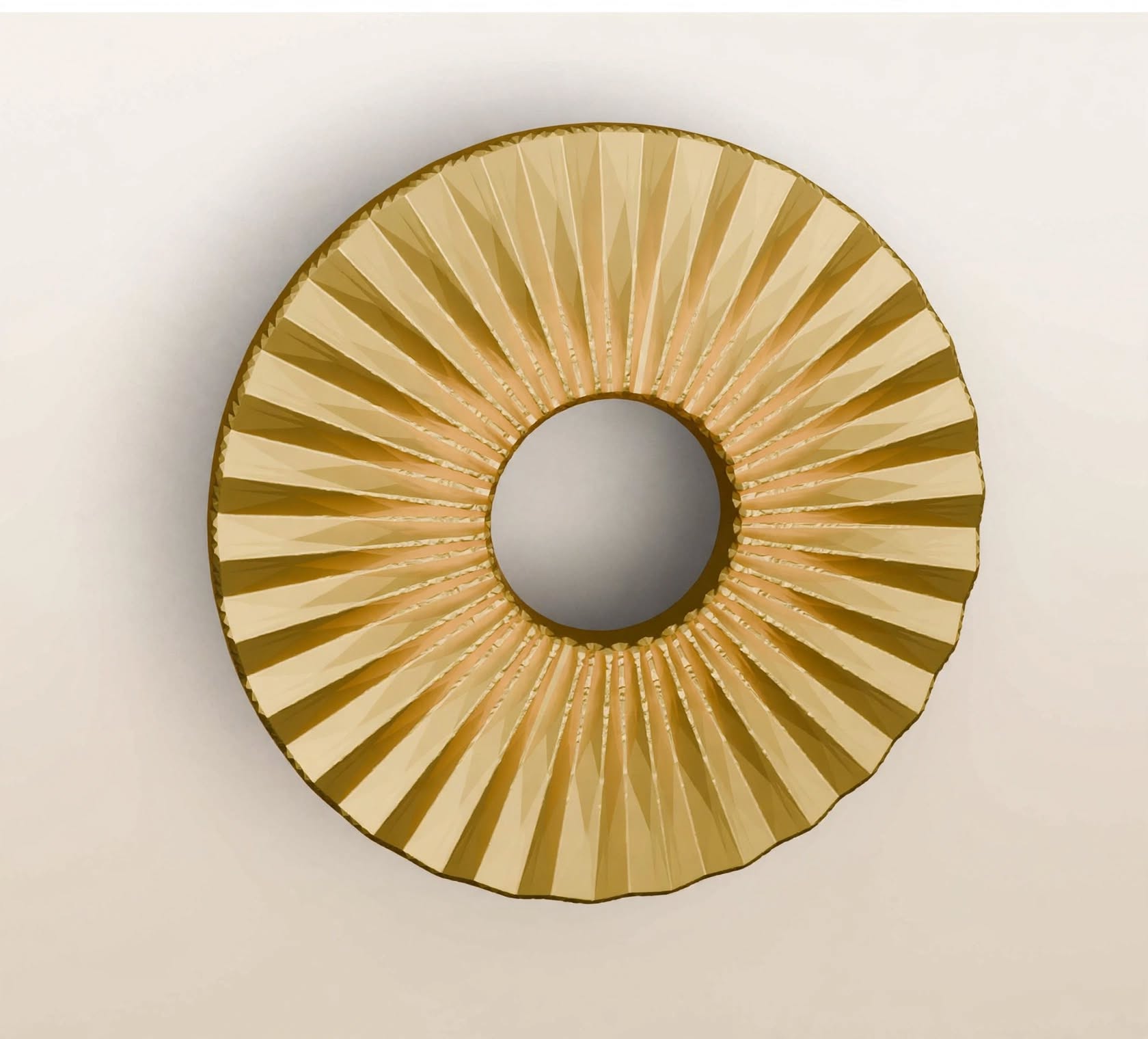 Top-down view of Stillium Oaza 2027 circular pull handle in polished gold finish featuring a pleated sunburst texture made of Zamak alloy